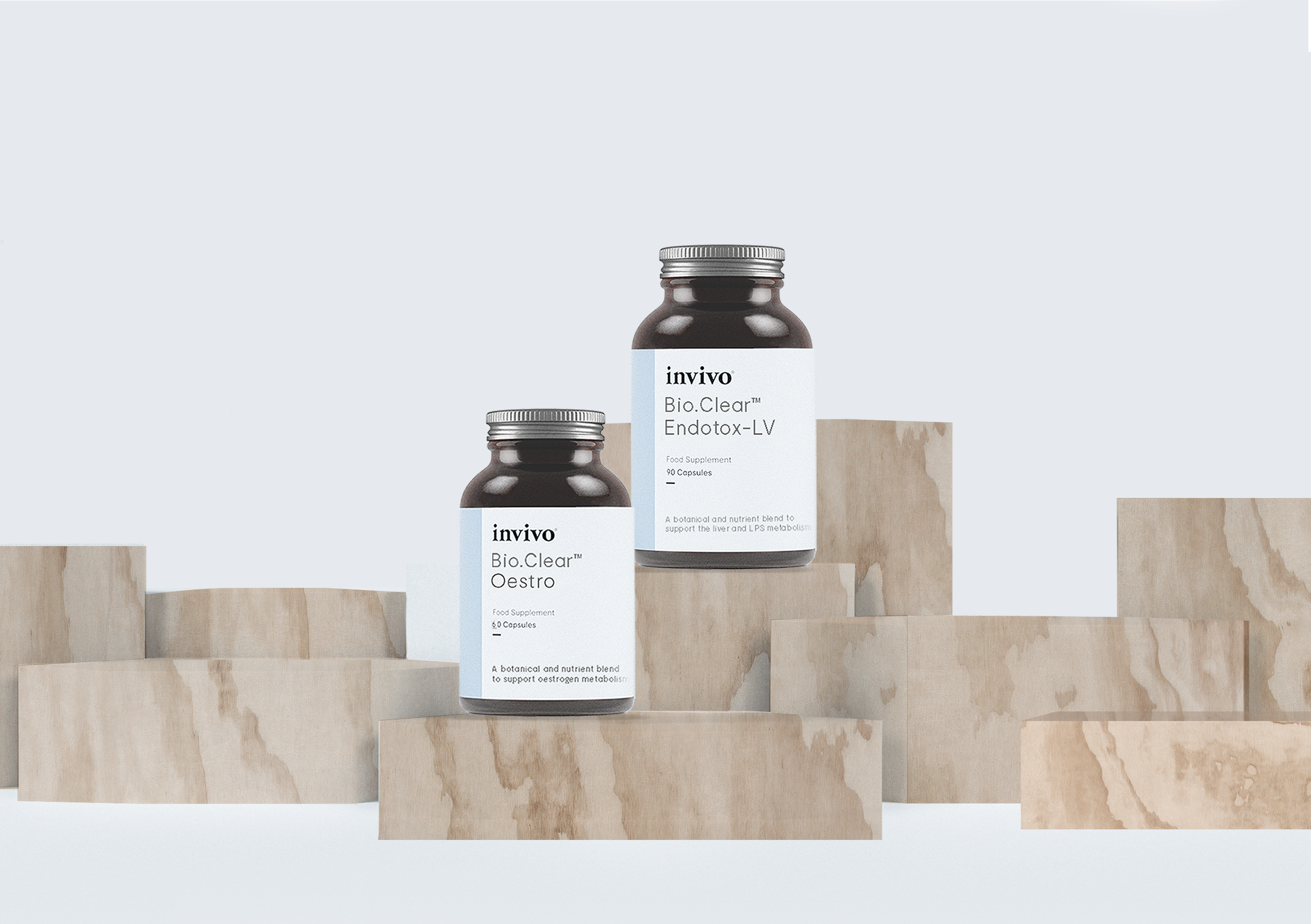 Invivo Bio.Clear supplement bottles displayed on wooden blocks