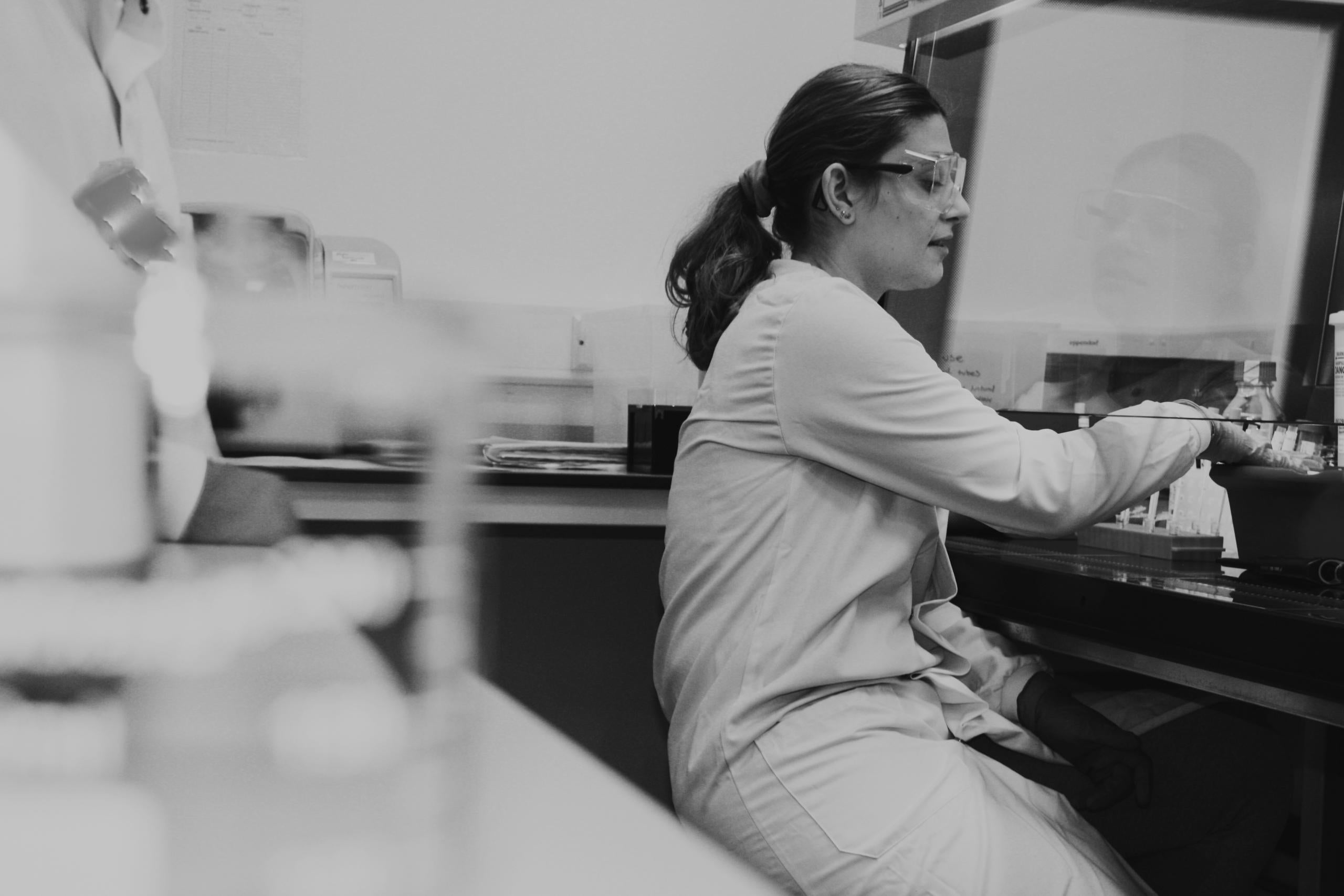 Black and white photograph of a scientist working in a laboratory