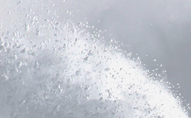 White powder scattered on a grey background