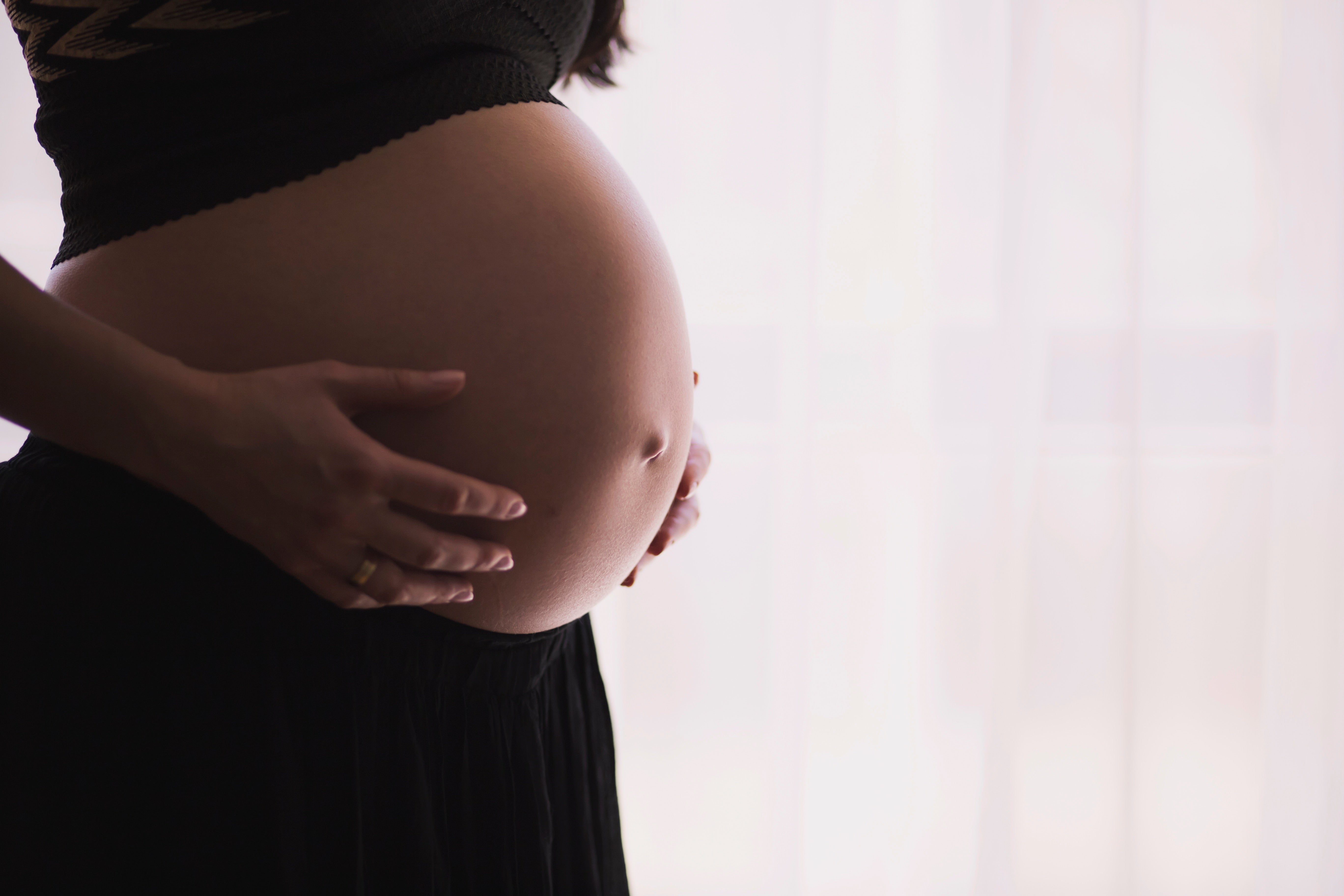Pregnant woman holding her bump