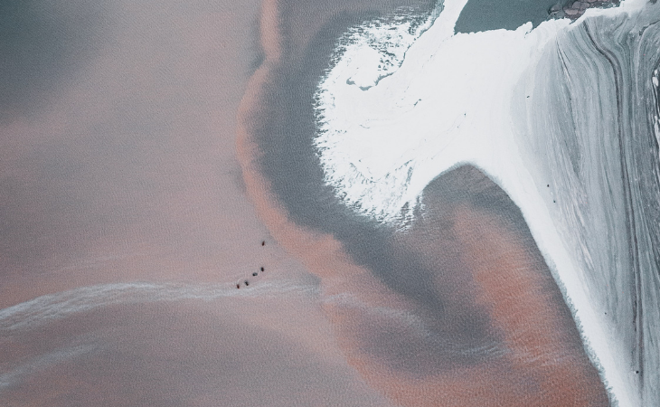 Aerial view of a coastline with white sand
