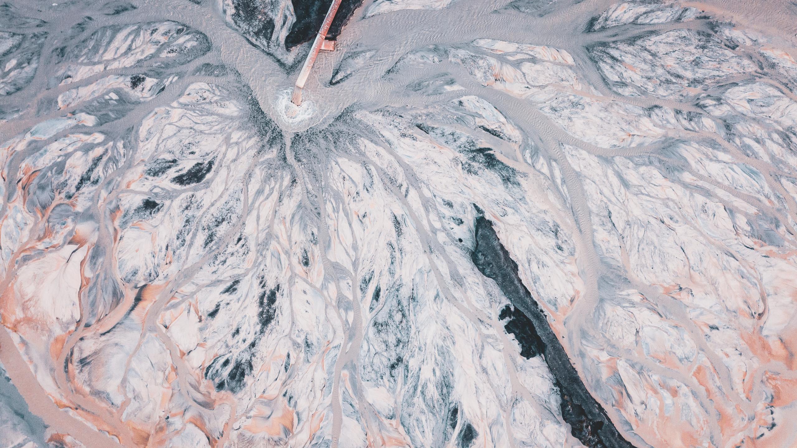 Aerial view of a pink and white river delta