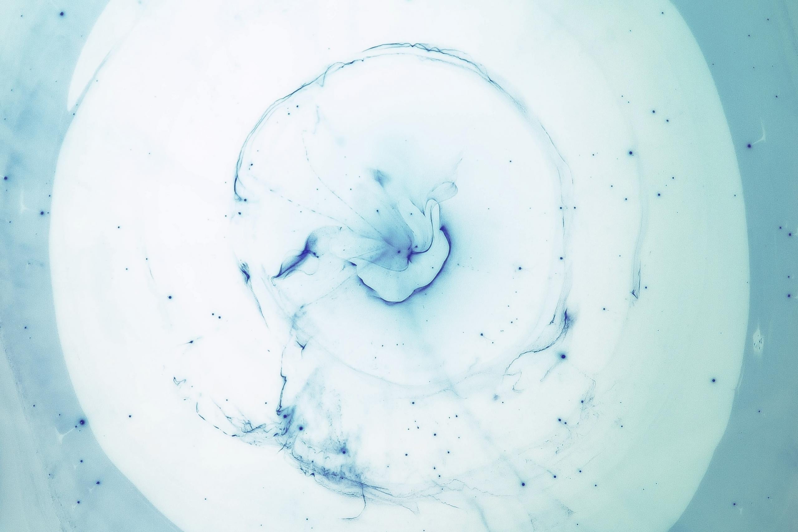 Pale blue ink dispersing in water